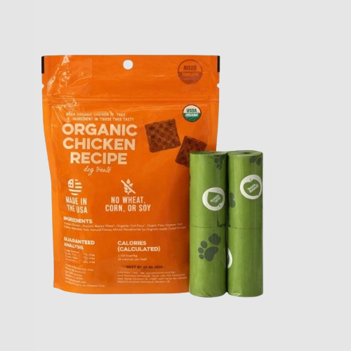 Orange package of organic chicken recipe dog food with two green rolls on a gray background